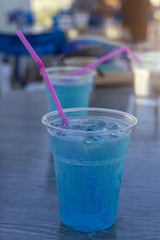 Tropical Mocktail - Plastic glass of Blue Hawaii Italian Soda with lemon