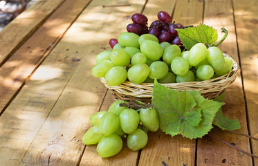 Basket of White Grapes on a Rustic Wooden Surface