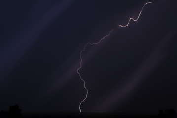 Cloudy dark sky with single huge lightning