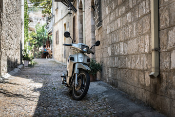 Motorbike at narrow street of Rhodes town on Rhodes island, Greece