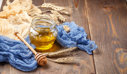 Still life with jar of honey and spikelets