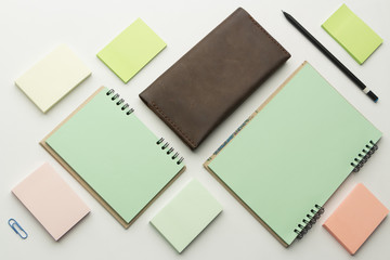 Modern samples of stationery, notebooks, stickers and pencils.