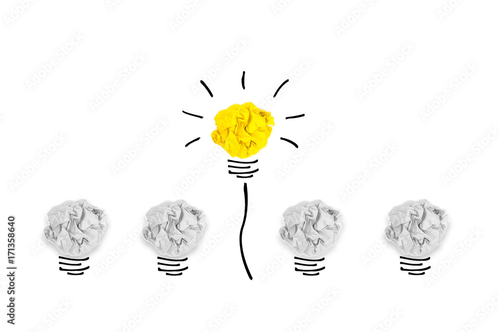 Wall mural creative concept. yellow light bulb outstanding on bulb crumpled paper on white background