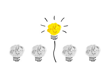 Creative concept. Yellow light bulb outstanding on  bulb crumpled paper on white background