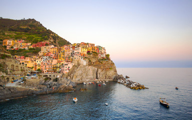 Fototapeta na wymiar Beautiful view of Manarola one of five famous colorful villages of Cinque Terre National Park in Italy on sheer cliffs, Unesco famous colorful villages in Cinque Terre, Liguria Italy.