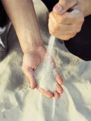 Sand flowing through your fingers. Hand with the sand.