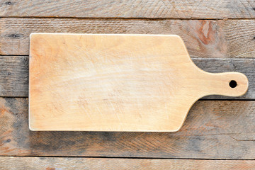 Empty vintage cutting board on planks food background concept