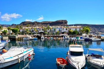 Fototapeta na wymiar Port and promenade of beautiful romantic picturesque village Puerto de Mogan on Gran Canaria.