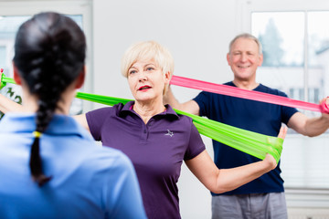 Older patients in physiotherapy using power band for strength training
