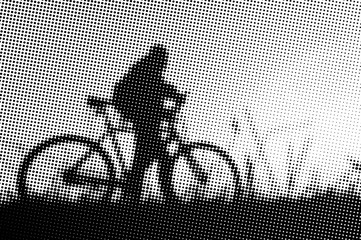 Man with bicycle at sunset - monochrome halftone pattern background