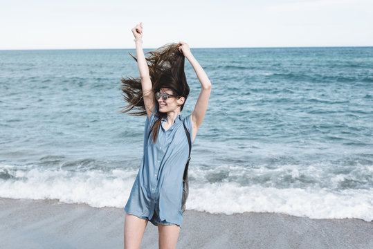 Young wild and free woman at the sea