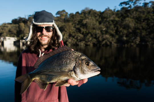 Young Man holding a Southern Black Bream