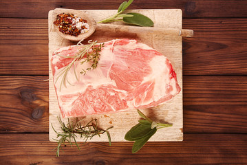 raw shoulder lamb on wooden board and table - 171365611