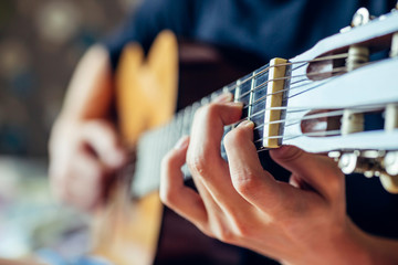 musician playing acoustic guitar, live music background