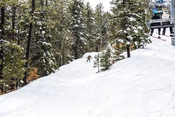 skier coming down a moderate trail at a ski resort