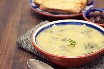 vegetable soup in bowl and olives with corn bread