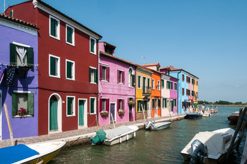 Fototapeta na wymiar Rainbow of colorful homes on a canal in Burano, Italy