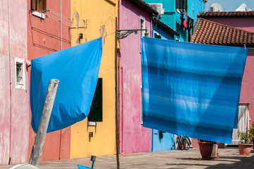 Fototapeta na wymiar Colorful Clean Sheets Hanging Out to Dry