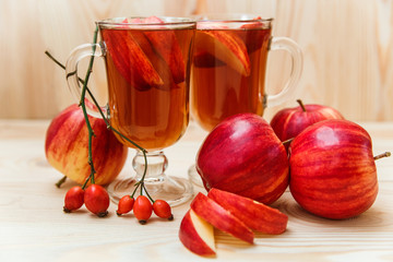 Beverage with autumn fruits.Apple,dogrose.Wood background.Fall concept