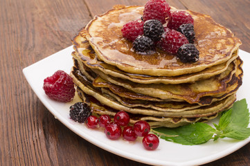 Delicious pancakes with berries and maple syrup