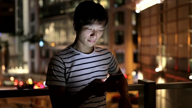 Man working on cellphone at night
