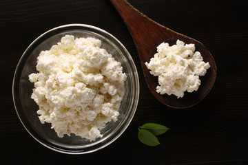 cottage cheese in a glass bowl on a dark background