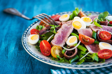 Tuna salad with tomatoes, boiled eggs, onion, anchovy and lettuce