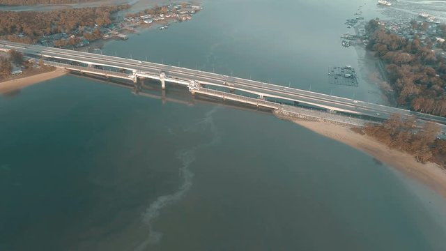 Aerial drone view of bridge and sea with visible oil leak from an industrial boat