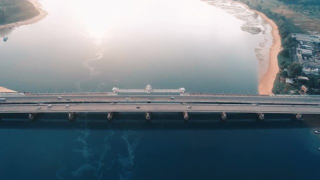 Aerial drone view of bridge and sea with visible oil leak from an industrial boat