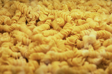 Italian Fusilli or Rotini helix shaped Macaroni Pasta food background
