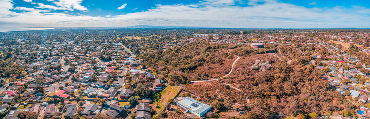 Aerial panorama of coastal suburb and parklands in Australia