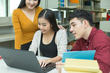 Group of Student reading books in the library with attractive smiling together . People with Education concept.