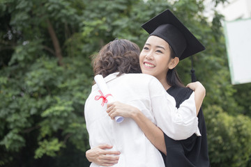 Young Asian Woman Students wearing Graduation hat and gown at University, Woman with Graduation...