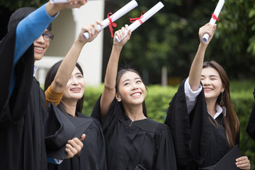 Young Asian Students showing certificate together with Happy emotion at University. People Success for Education Together. Students with Graduation Concept.