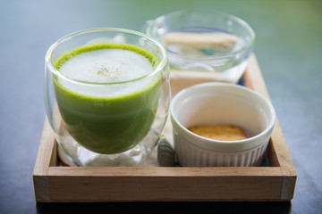 Cup of hot matcha green tea with milk foam