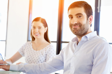 Fototapeta premium Image of two young business people in office