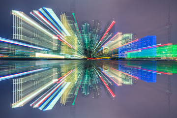 Blurred skyscrapers by night with bokeh lights trail using zoom technique