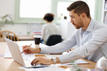 Young man architect in office