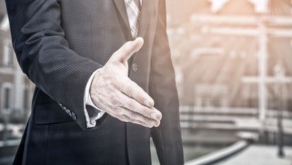 Business offer, partnership. Businessman holds out his hand