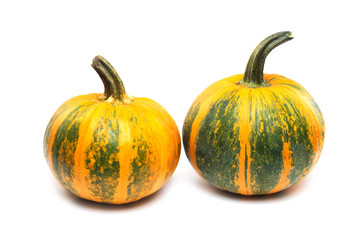 Two orange and green pumpkins with clipping path isolated at white background.
