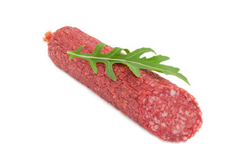 Salami and arugula leaf on a light background