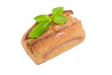 Wheat sourdough bread decorated with basil twig