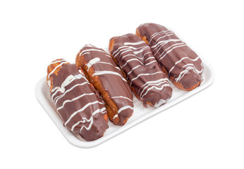 Eclairs with chocolate icing on a foam food container