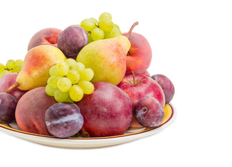 Different fruits on the big dish closeup