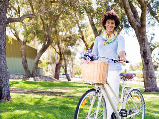 Naklejka na ściany i meble Happy young woman with bicycle
