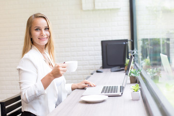 Woman using Laptop for Work at office. Smiling Businesswoman work at office Concept.