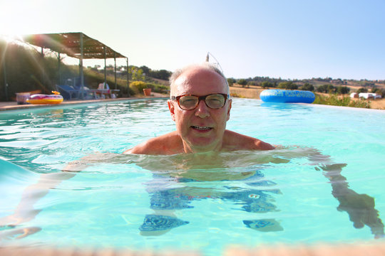 Mature man swimming in pool