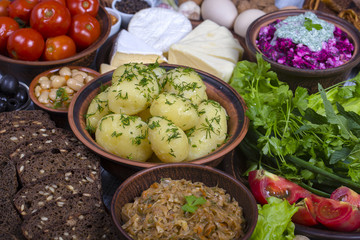 Assortment of cooked food and vegetables on the background. Close up