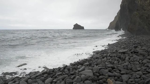 Sea wave incident on the coastal shingle. Madeira