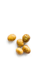 beautiful small rounded whole organic potato with the peel isolated on a white background. Vertical composition. Top view